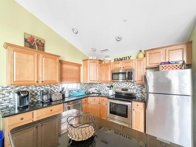 kitchen with sink, light brown cabinets, stainless steel appliances, tasteful backsplash, and vaulted ceiling