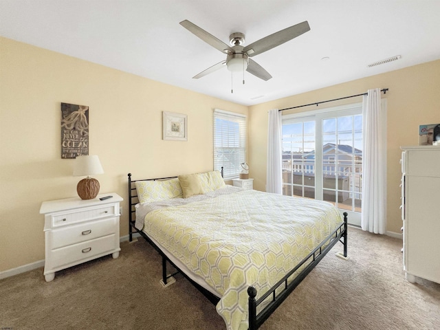 carpeted bedroom with ceiling fan and multiple windows