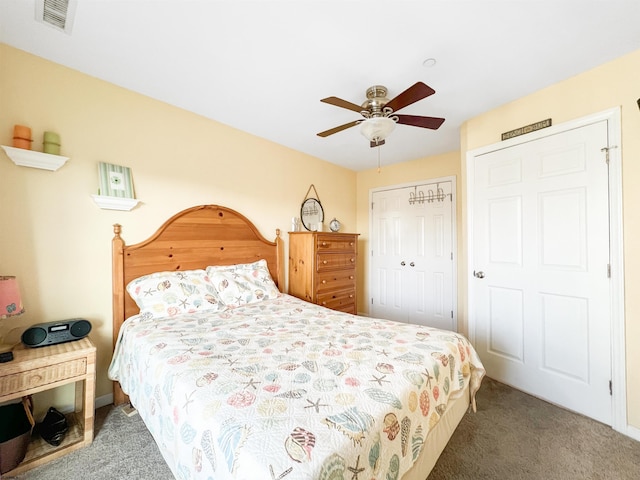 carpeted bedroom with ceiling fan and a closet