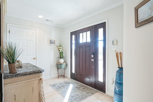 foyer entrance featuring ornamental molding and light tile patterned flooring