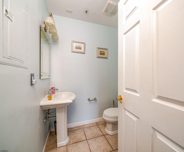 bathroom with tile patterned floors and toilet