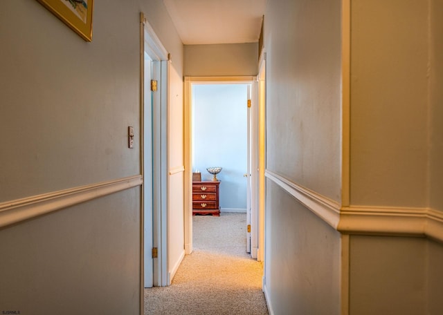 hall with light colored carpet