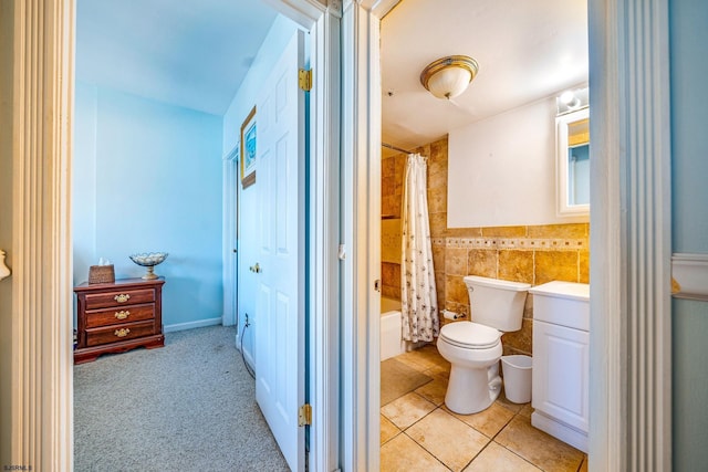 full bathroom featuring tile patterned floors, vanity, shower / tub combo with curtain, tile walls, and toilet