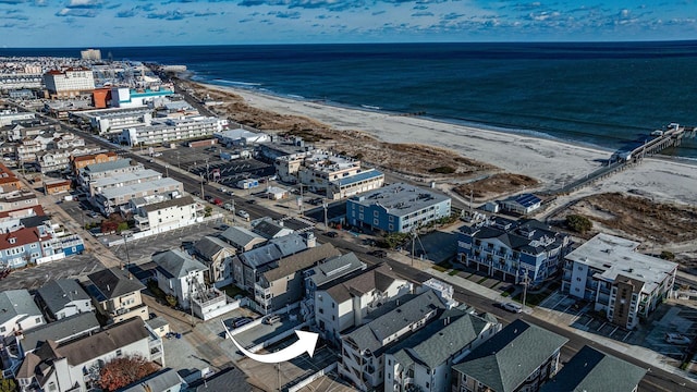 birds eye view of property with a beach view and a water view