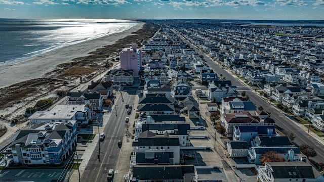 bird's eye view featuring a water view and a beach view