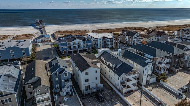 drone / aerial view featuring a water view and a beach view