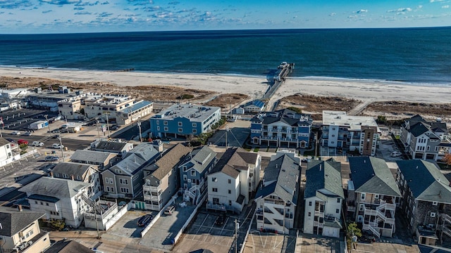 birds eye view of property featuring a view of the beach and a water view