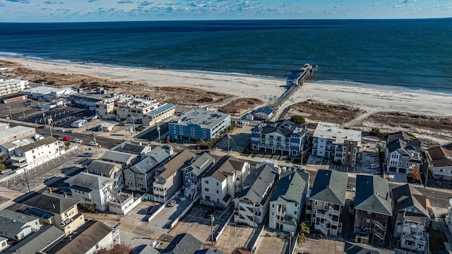 birds eye view of property with a water view and a view of the beach