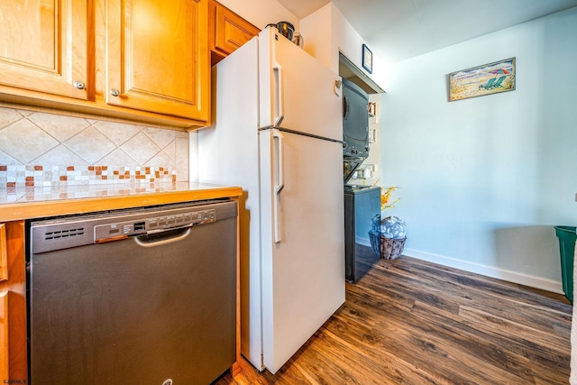 kitchen with dark hardwood / wood-style flooring, tasteful backsplash, stainless steel dishwasher, white refrigerator, and stacked washer and dryer