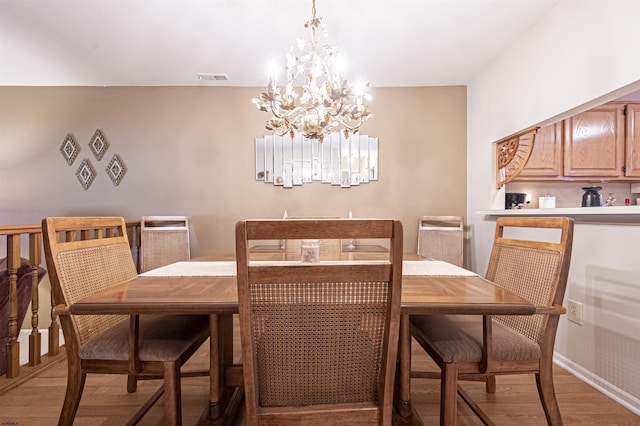 dining space featuring a chandelier and light hardwood / wood-style floors