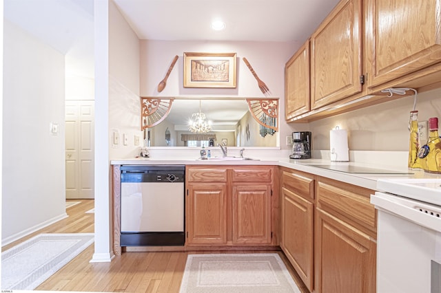 kitchen with an inviting chandelier, white range, sink, light hardwood / wood-style flooring, and dishwashing machine