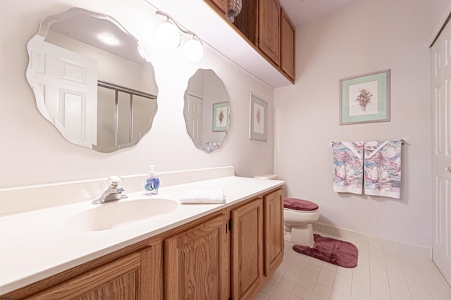 bathroom featuring tile patterned floors, vanity, and toilet