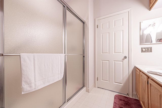 bathroom with tile patterned floors, vanity, and a shower with shower door