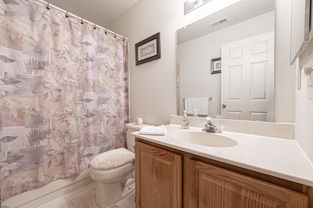 bathroom with tile patterned flooring, vanity, and toilet