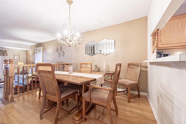 dining room with a chandelier and light wood-type flooring