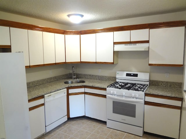 kitchen featuring light stone counters, a textured ceiling, white appliances, sink, and white cabinets