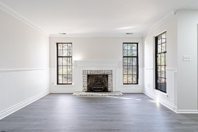 unfurnished living room with dark hardwood / wood-style floors, ornamental molding, and a fireplace