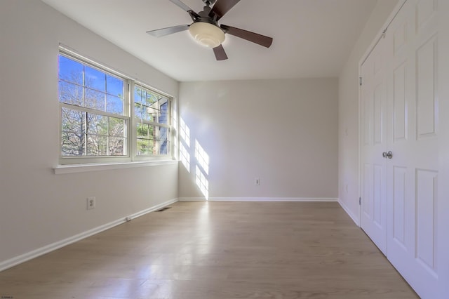 spare room featuring light wood-type flooring and ceiling fan