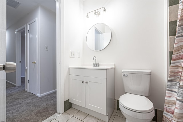 bathroom with tile patterned flooring, vanity, and toilet