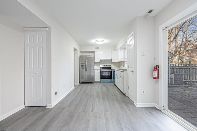 kitchen with sink, light wood-type flooring, white cabinetry, and stainless steel appliances