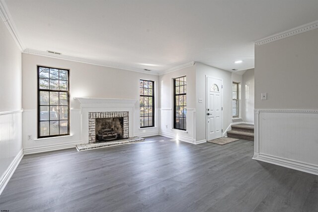 unfurnished living room featuring crown molding, plenty of natural light, and dark wood-type flooring