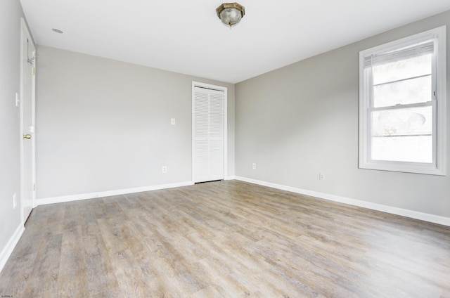 empty room with light hardwood / wood-style flooring