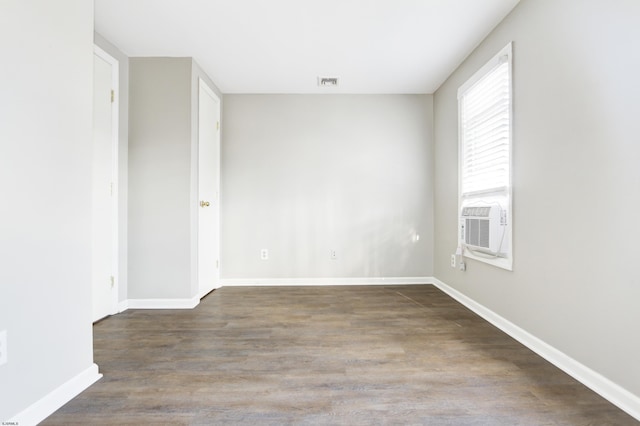 empty room with cooling unit and wood-type flooring