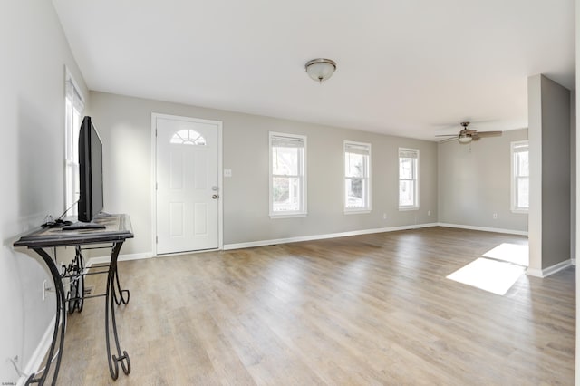 foyer with ceiling fan and light wood-type flooring