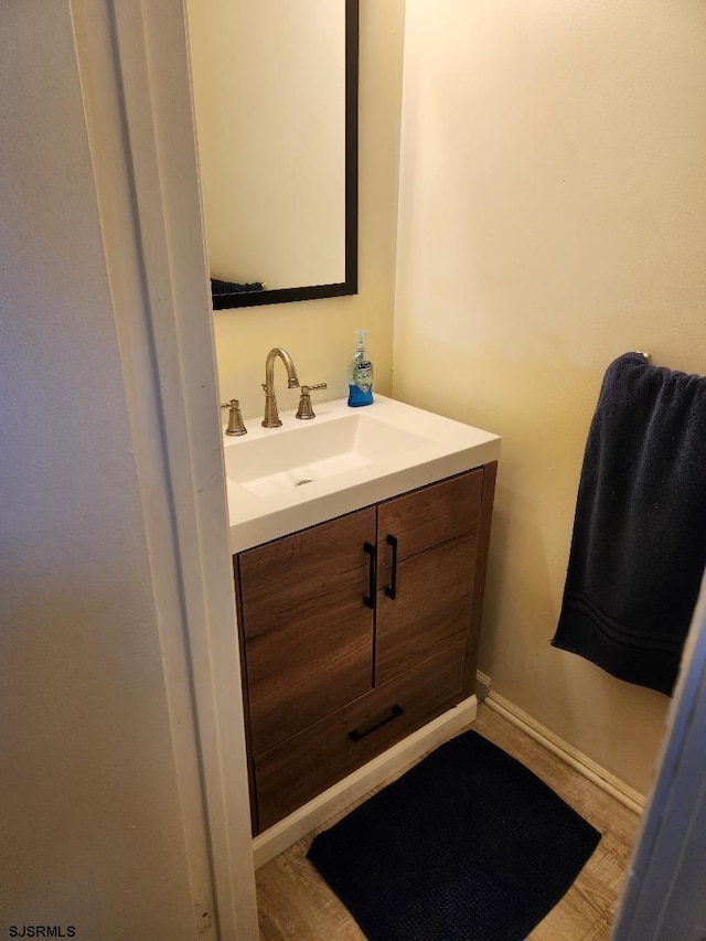 bathroom with hardwood / wood-style flooring and vanity