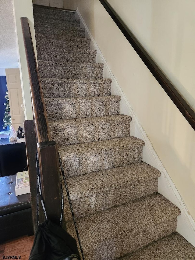 stairway featuring hardwood / wood-style floors