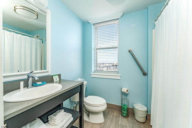 bathroom featuring vanity, hardwood / wood-style flooring, and toilet