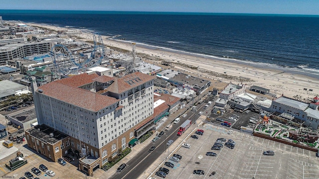 birds eye view of property with a beach view and a water view