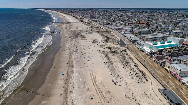 aerial view featuring a view of the beach and a water view