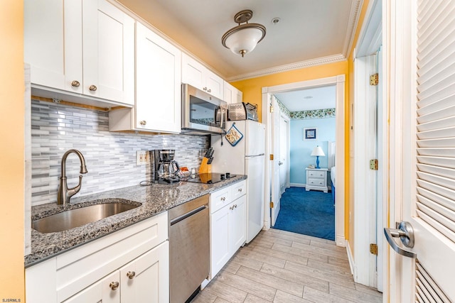 kitchen with white cabinets, light stone counters, sink, and stainless steel appliances