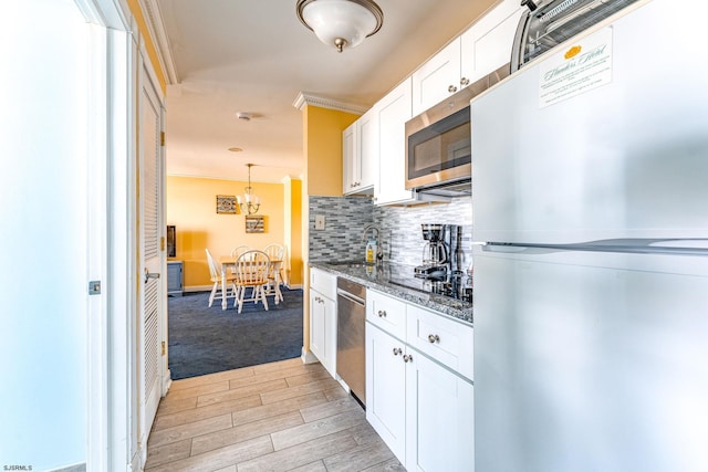 kitchen featuring white cabinets, crown molding, sink, light hardwood / wood-style floors, and stainless steel appliances