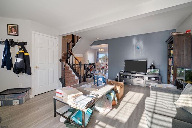 living room featuring light hardwood / wood-style flooring and a notable chandelier