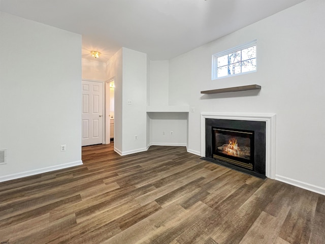 unfurnished living room featuring dark wood-type flooring