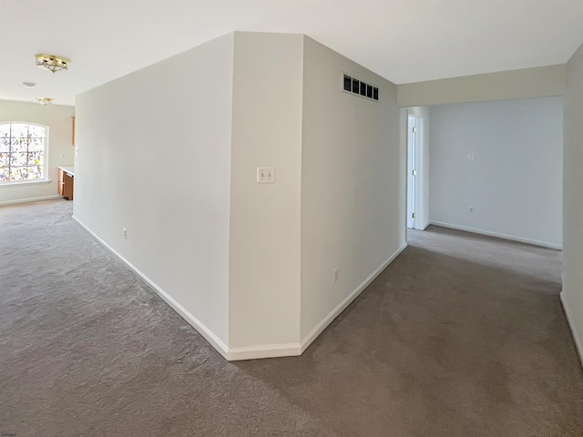 hallway featuring carpet and a chandelier