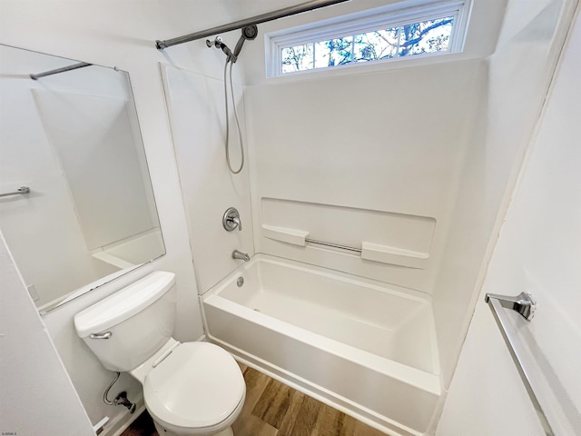 bathroom featuring shower / tub combination, wood-type flooring, and toilet