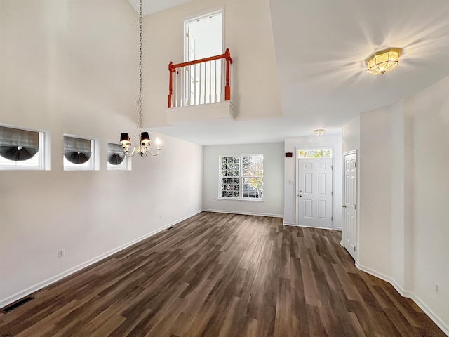 entryway with a chandelier and dark hardwood / wood-style flooring