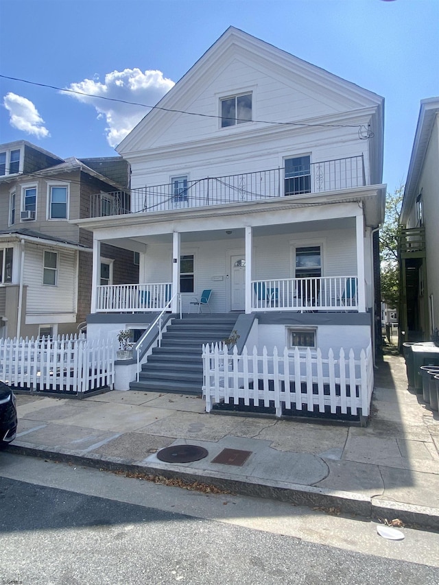 view of front of house with covered porch and a balcony