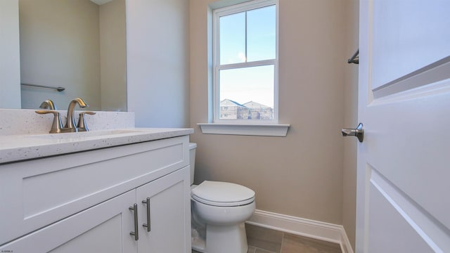 bathroom with tile patterned floors, vanity, and toilet