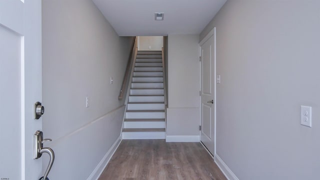 stairway with hardwood / wood-style floors