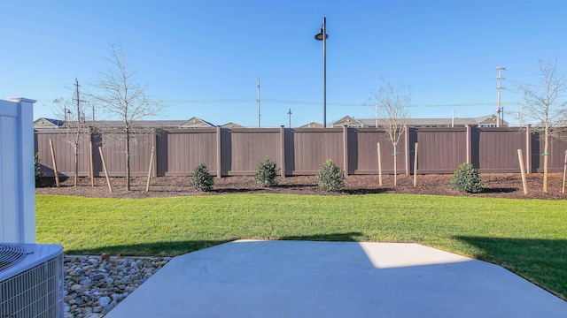 view of yard featuring a patio and central AC unit