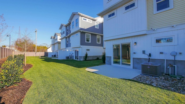 rear view of house with a yard and central air condition unit