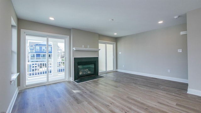 unfurnished living room with hardwood / wood-style flooring