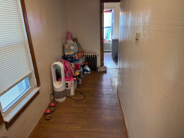 corridor with radiator and wood-type flooring