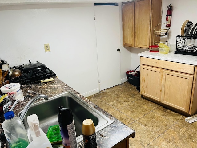 kitchen featuring sink, light tile patterned flooring, and light brown cabinets