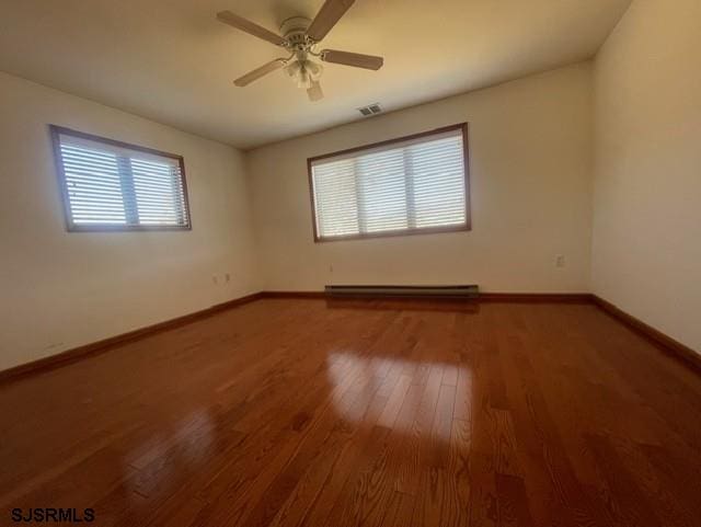 unfurnished room featuring ceiling fan, hardwood / wood-style floors, a healthy amount of sunlight, and a baseboard radiator