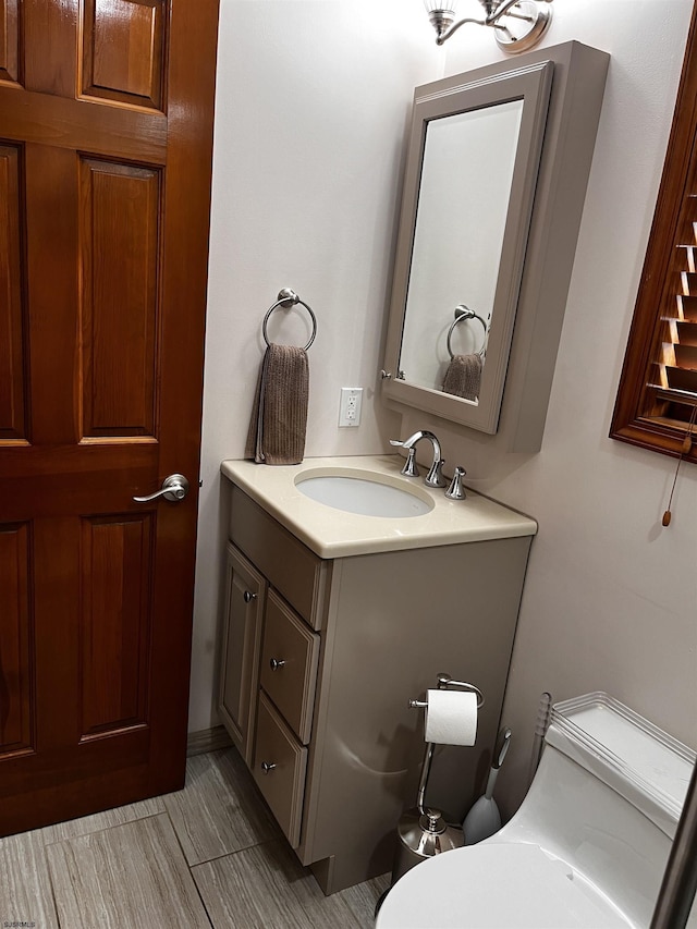 bathroom featuring vanity and toilet